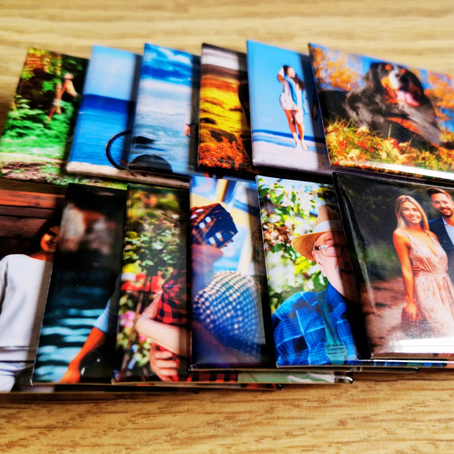 Two horizontal rows of stacked magnets, each row containing several magnets aligned neatly. The top row is positioned above the bottom row, with the magnets arranged in a clean, orderly fashion, showcasing their various designs or images.