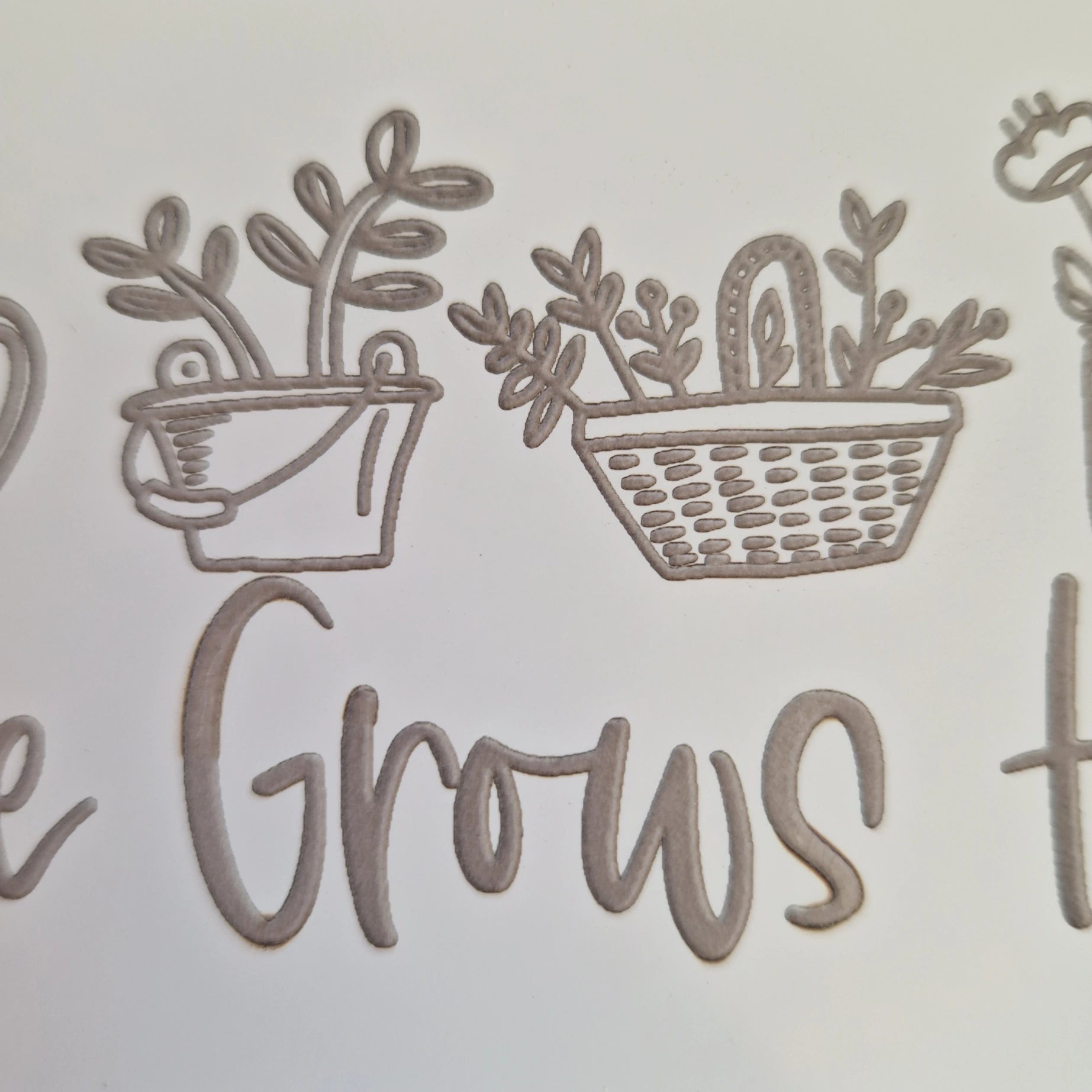 Close-up view of the detailed engraving on the ceramic garden tile.