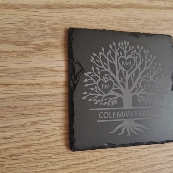 Close-up view of an engraved family tree design on a slate coaster, showcasing intricate details and customisation options for a personalised gift.